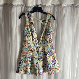 Beautiful summertime vibrant short romper with back out and low Vshape neck line